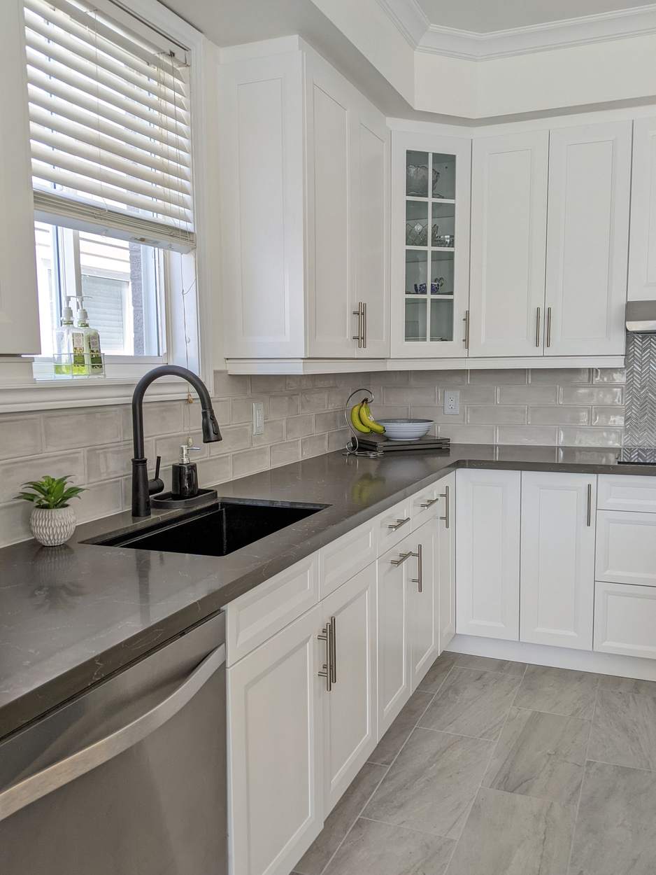 Chef's Kitchen and Entertainer's Basement, Whitby: Corner sink with a black faucet, glass-front cabinets and stainless dishwasher