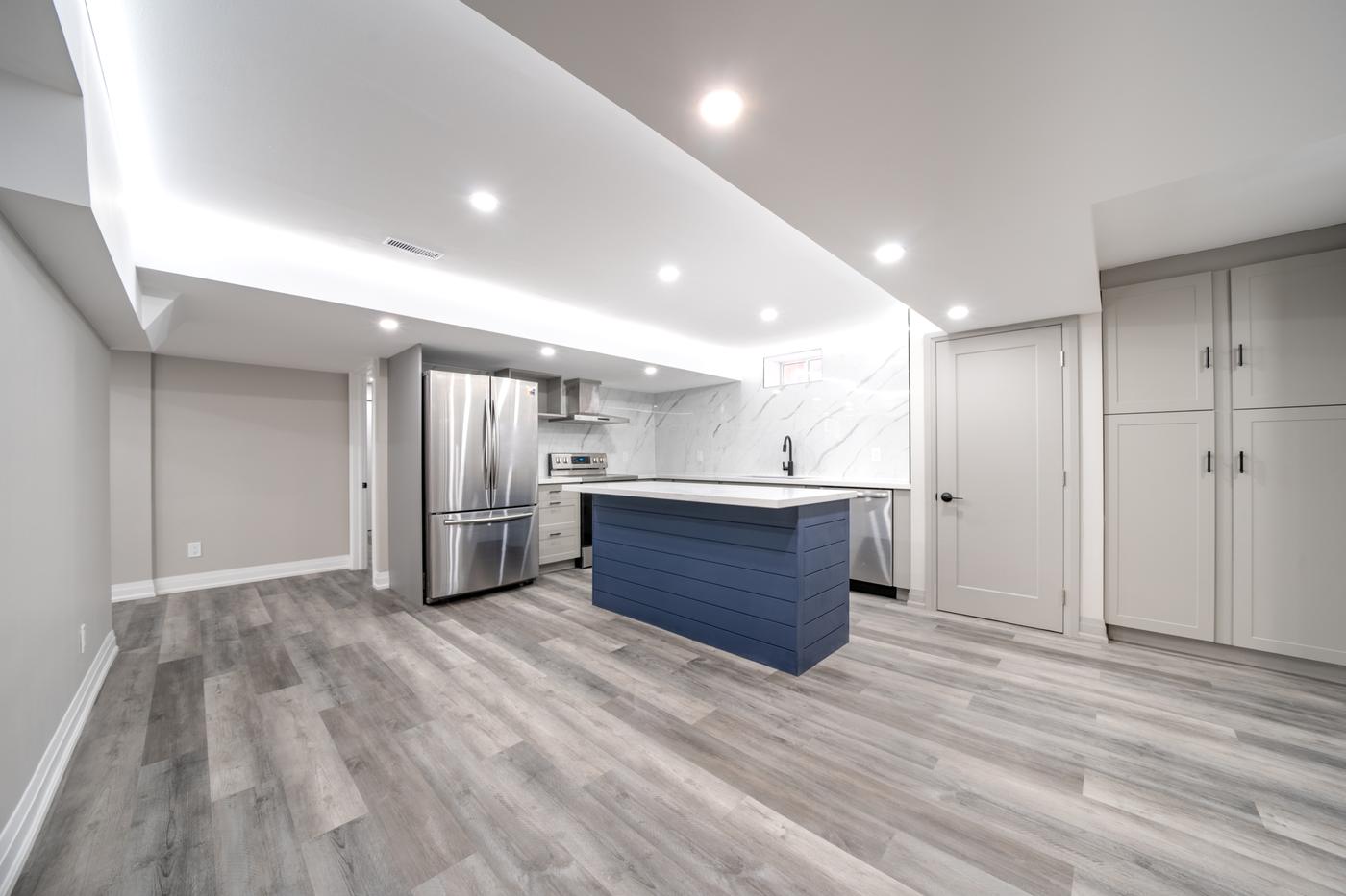 Open-Concept Basement Suite, Oshawa: Open-concept basement kitchen with a navy shiplap island