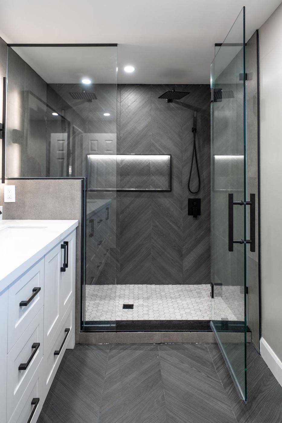 Slate Chevron Spa Bathroom, Ajax: Frameless glass shower door on a chevron feature wall