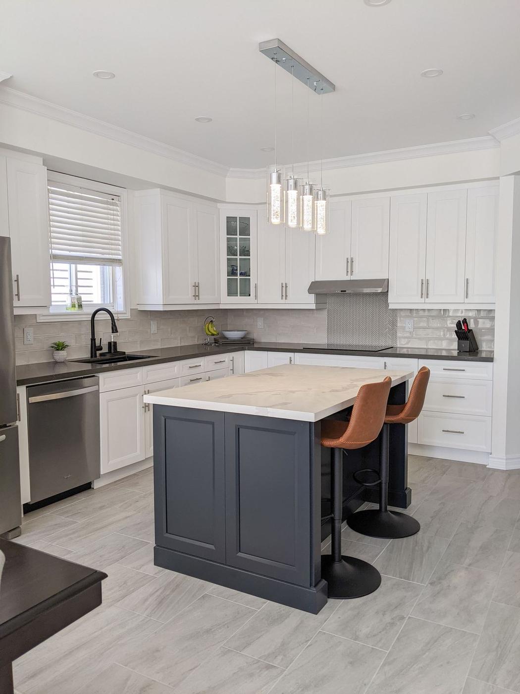 Chef's Kitchen and Entertainer's Basement, Whitby: Island with a veined quartz top, pendant lights and shaker cabinets