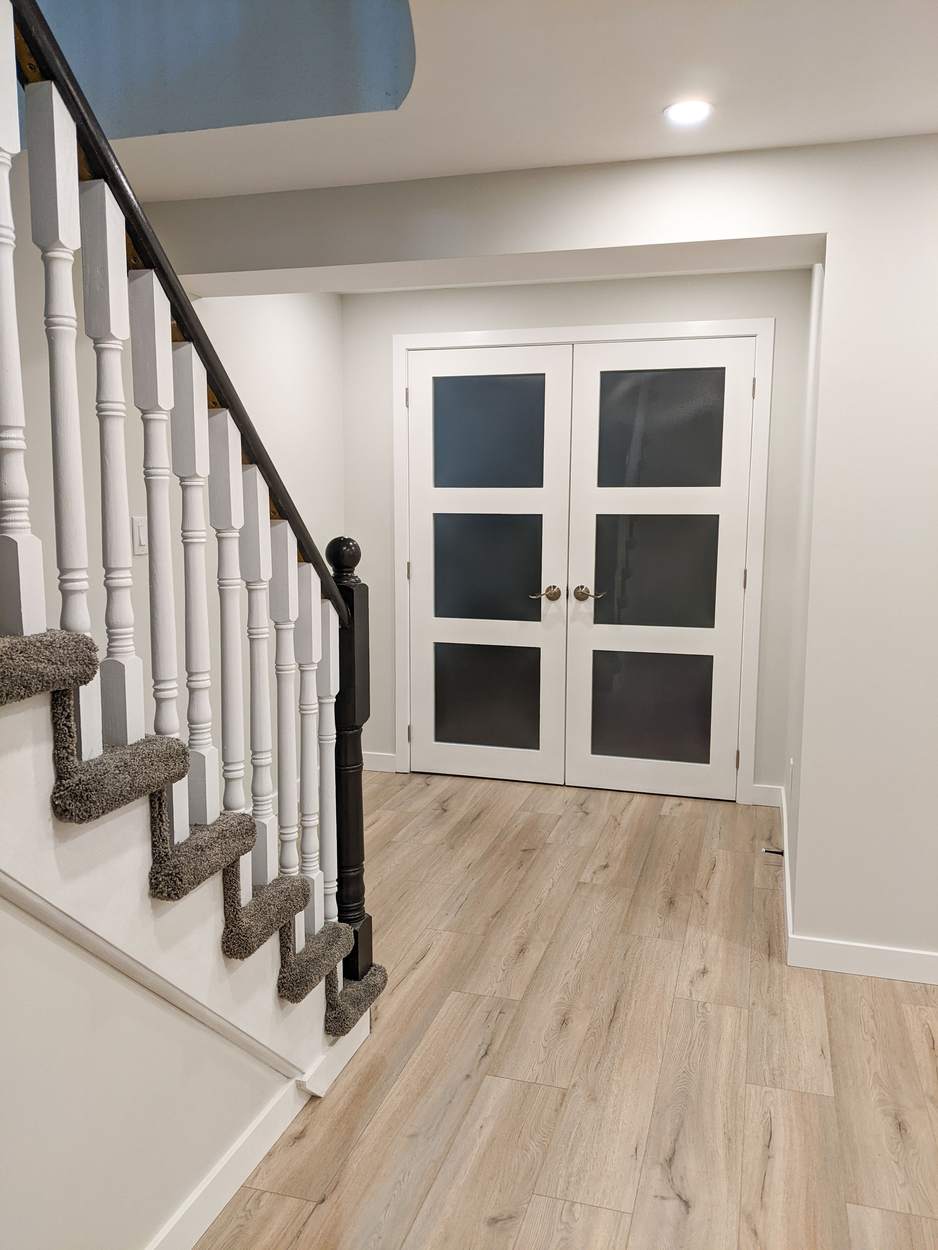 Chef's Kitchen and Entertainer's Basement, Whitby: Basement staircase with black-capped spindles and double glass doors