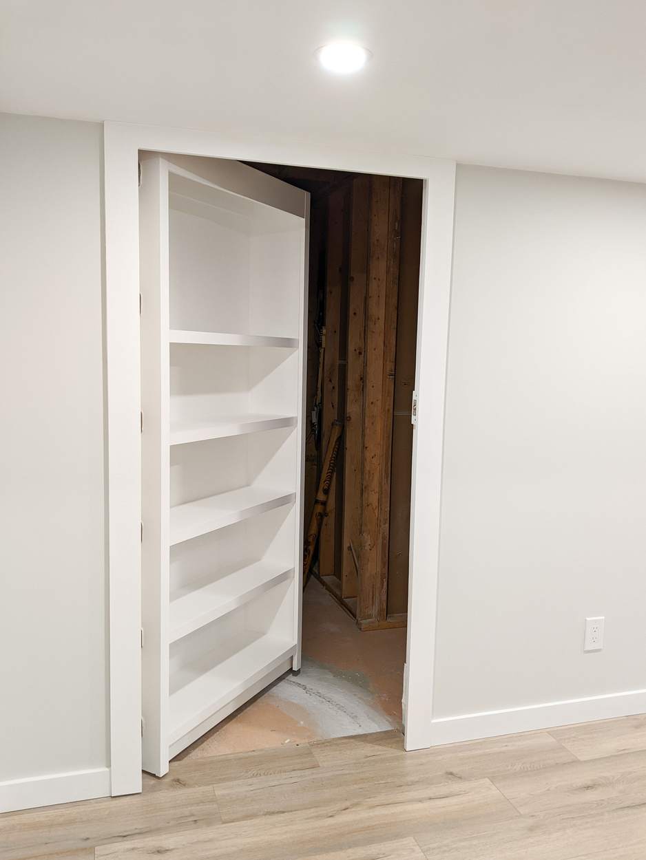Chef's Kitchen and Entertainer's Basement, Whitby: Bookshelf door open to reveal a storage room
