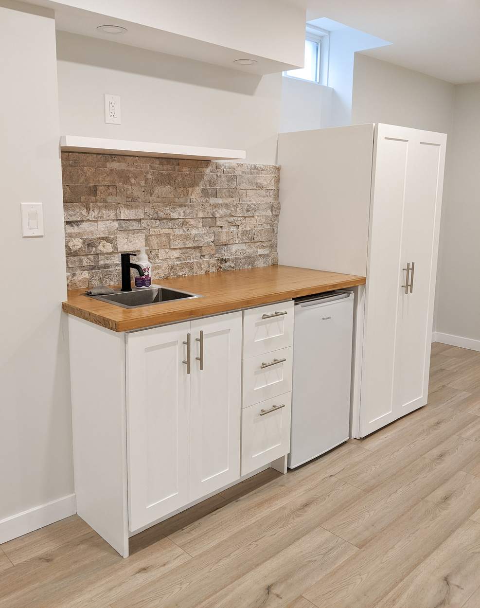 Chef's Kitchen and Entertainer's Basement, Whitby: Basement kitchenette with a bamboo counter, stone backsplash and tall pantry cabinet