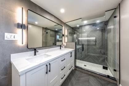 Slate Chevron Spa Bathroom, Ajax: Double vanity and glass shower in dark chevron tile
