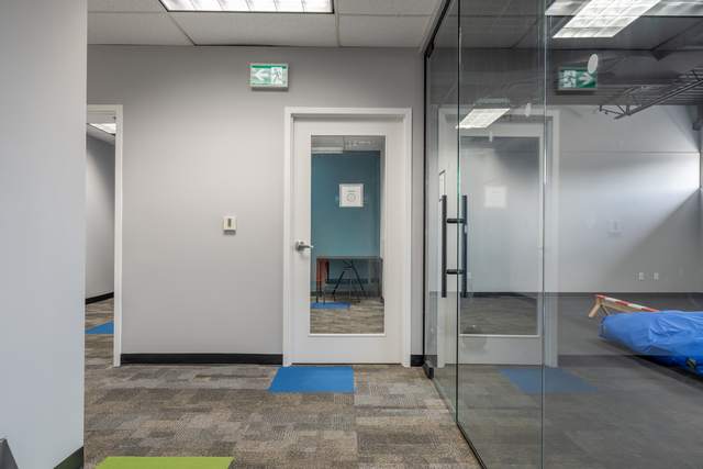 Dots for Kids Occupational Therapy Centre, Whitby: Hallway view through a glass-walled therapy room