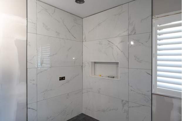Marble and Navy Primary Ensuite, Courtice: Tiled shower with niche before the glass