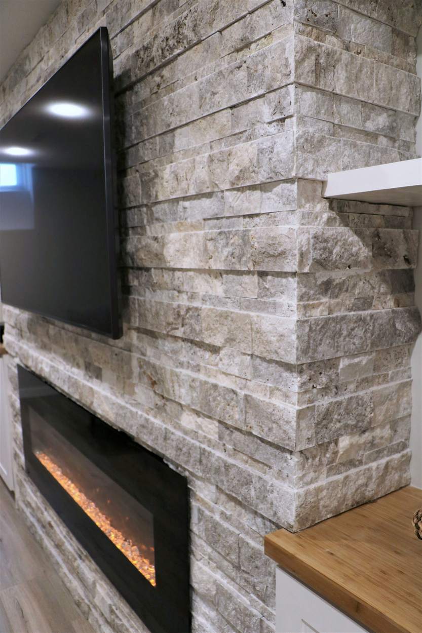 Chef's Kitchen and Entertainer's Basement, Whitby: Split-face stone wall around the fireplace beside a bamboo countertop