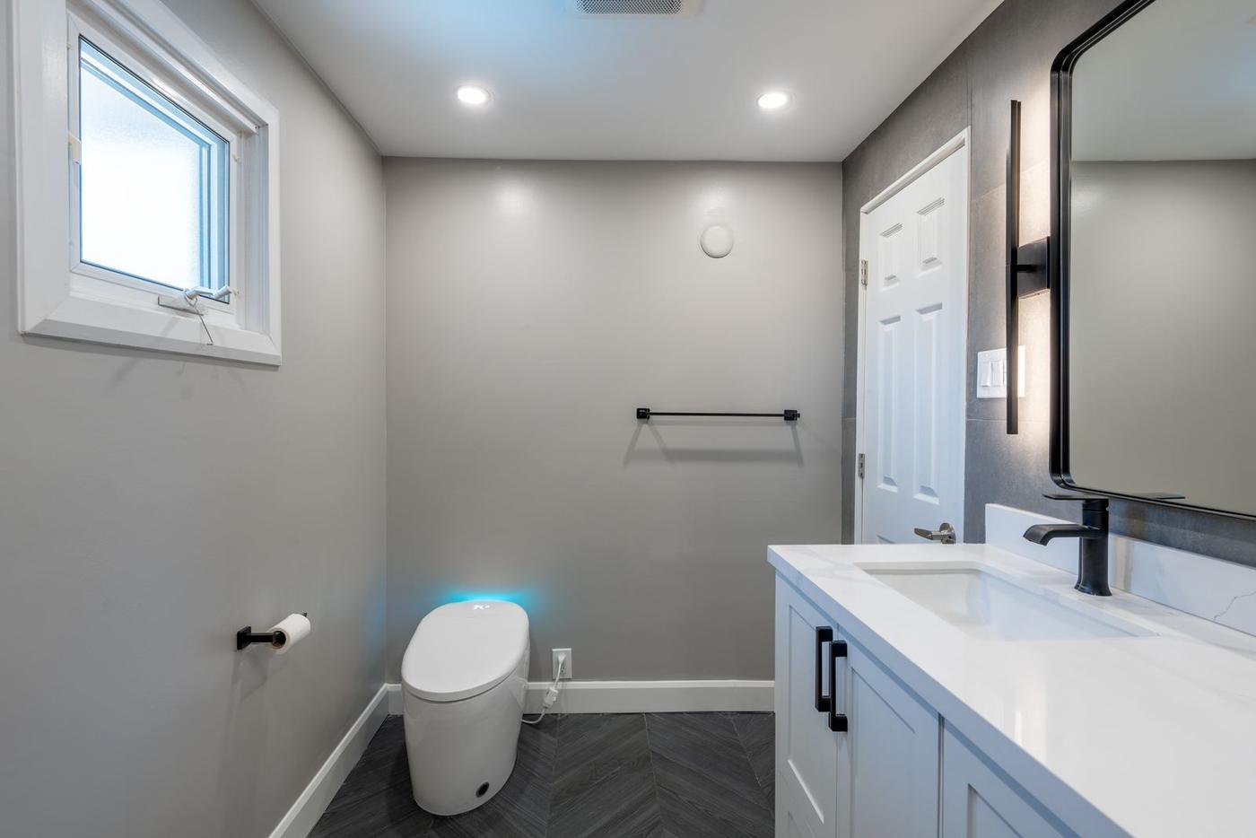 Slate Chevron Spa Bathroom, Ajax: Smart toilet, black towel bar and bathroom window