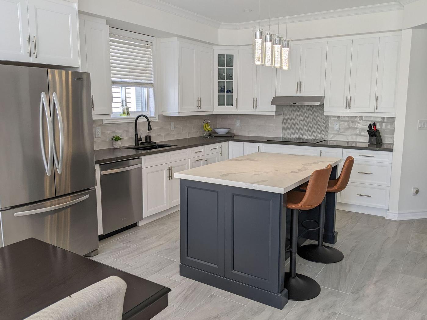 Chef's Kitchen and Entertainer's Basement, Whitby: Kitchen with white shaker cabinets, charcoal island and leather stools