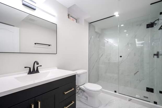 Open-Concept Basement Suite, Oshawa: Bathroom with a vanity and glass shower