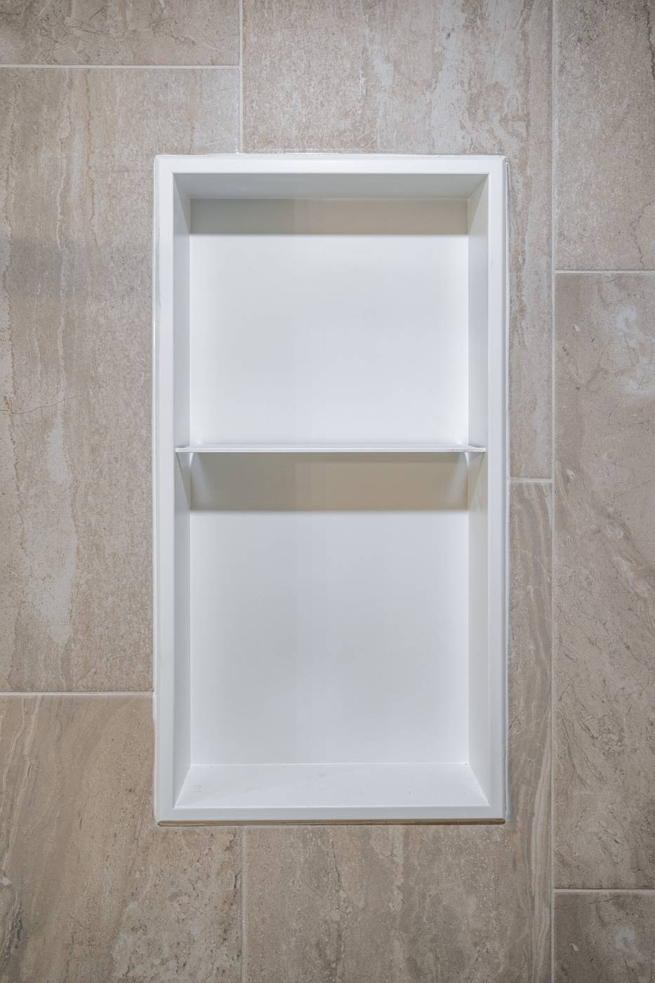 Taupe Herringbone Bathroom Retreat, Whitby: Recessed white shower niche set in large-format tile