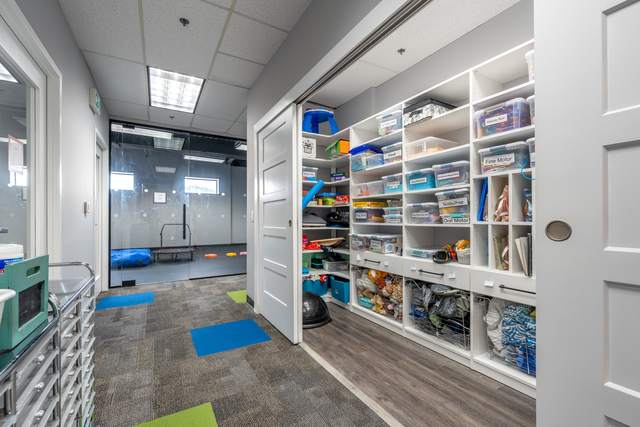 Dots for Kids Occupational Therapy Centre, Whitby: Storage room with floor-to-ceiling labelled therapy supply bins