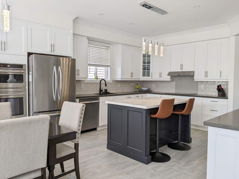 Chef's Kitchen and Entertainer's Basement, Whitby: White kitchen with a charcoal island, leather stools and stainless appliances