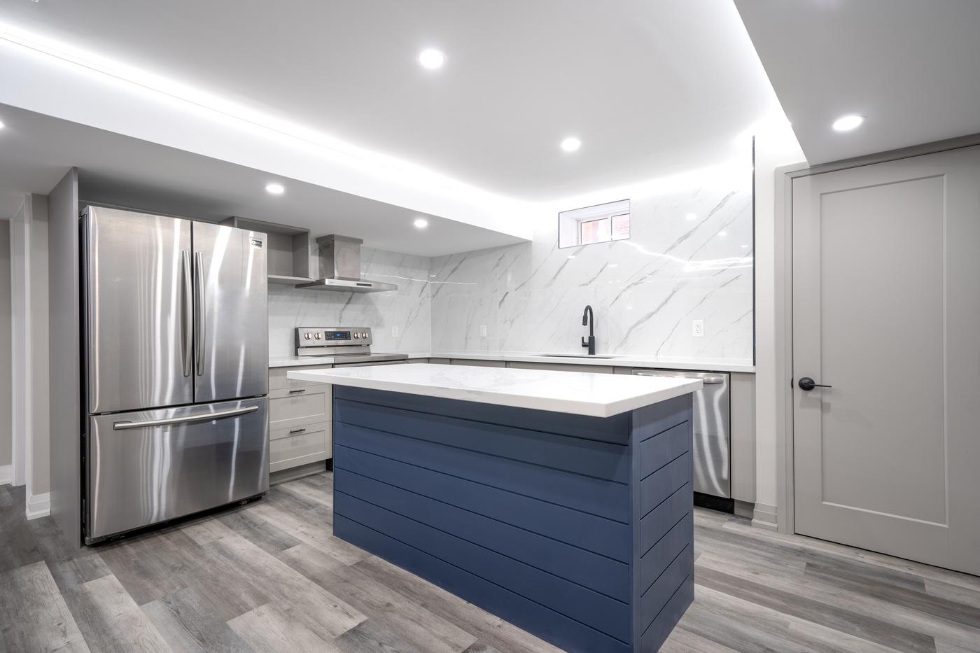 Open-Concept Basement Suite, Oshawa: Kitchen island with a stainless refrigerator and lit ceiling