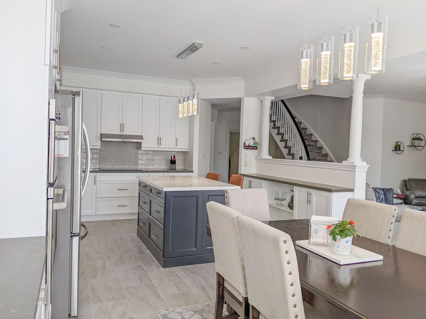 Chef's Kitchen and Entertainer's Basement, Whitby: Kitchen and dining area with the curved staircase beyond