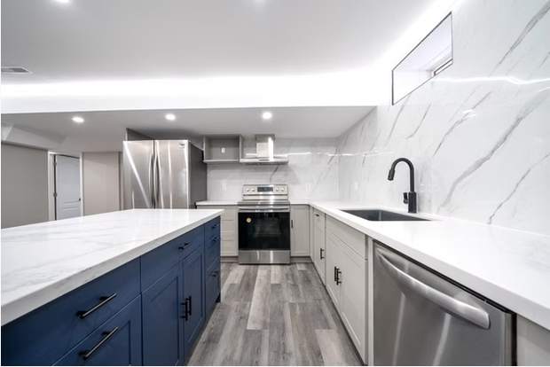 Open-Concept Basement Suite, Oshawa: Kitchen with a blue island and stainless appliances