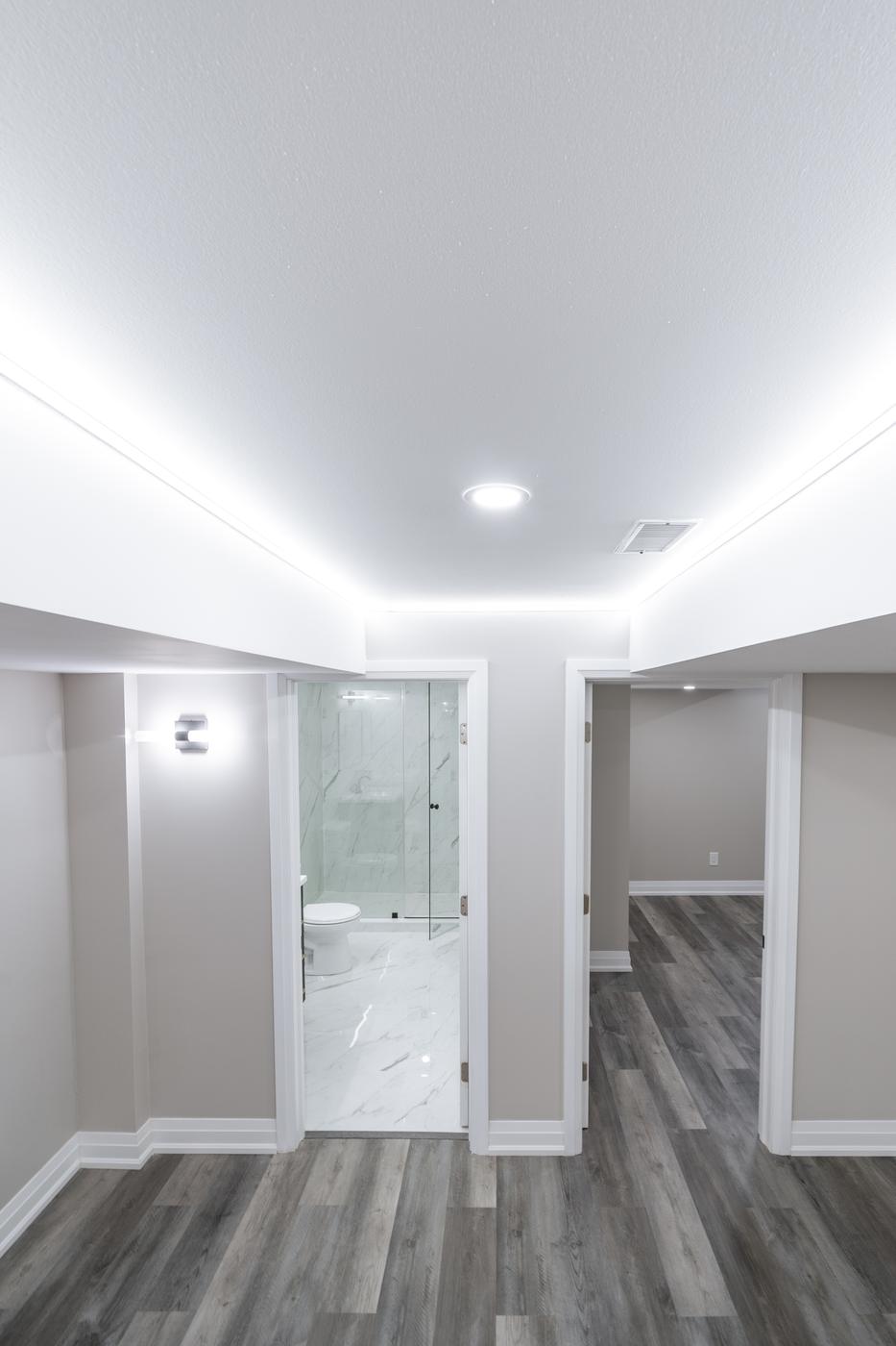Open-Concept Basement Suite, Oshawa: Hallway with cove lighting leading to the bathroom