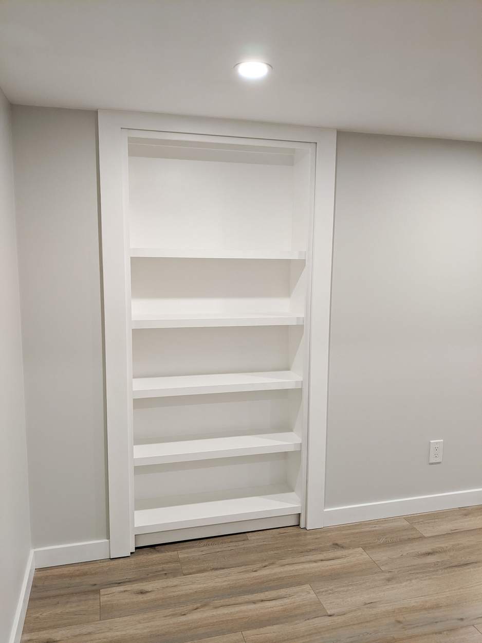 Chef's Kitchen and Entertainer's Basement, Whitby: Hidden bookshelf door built into the basement wall