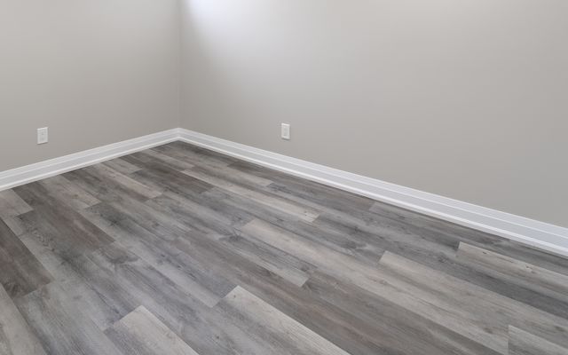 Grey wood-look luxury vinyl plank floor in a basement