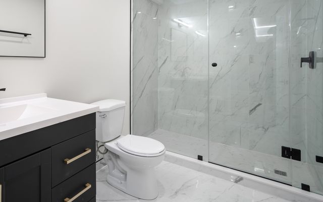 Marble-look porcelain floor and shower in a basement bathroom