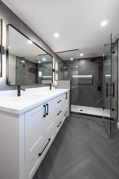 Slate Chevron Spa Bathroom, Ajax: White double vanity over a chevron tile floor