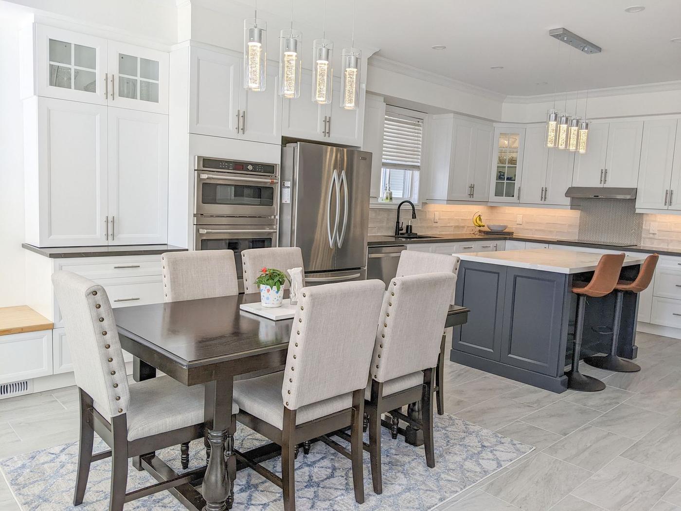 Chef's Kitchen and Entertainer's Basement, Whitby: Kitchen and dining area with glass-front cabinets and double wall ovens