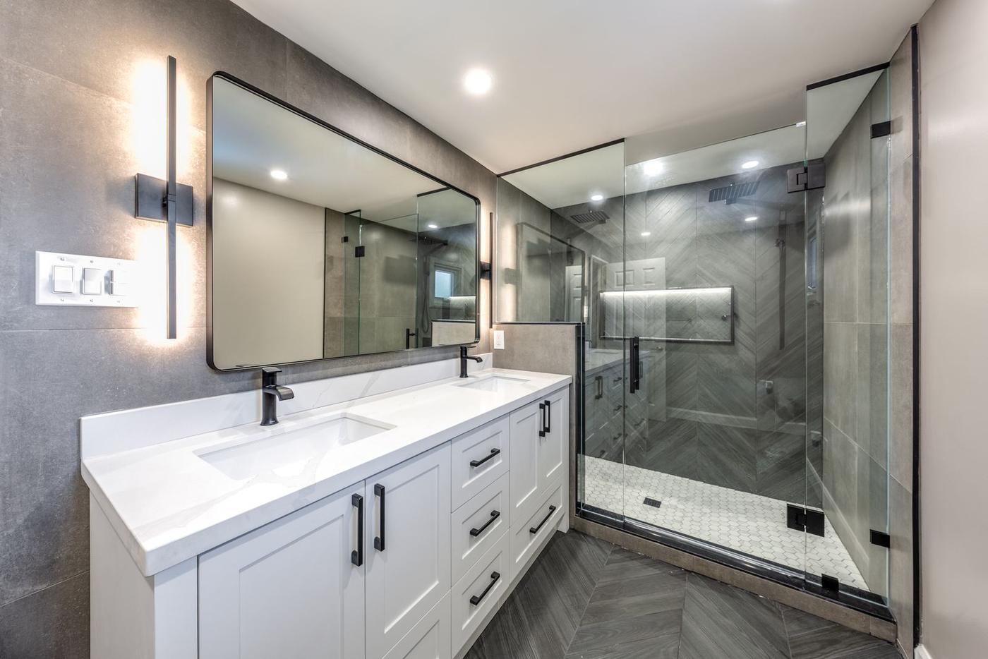 Slate Chevron Spa Bathroom, Ajax: Double vanity and glass shower in dark chevron tile