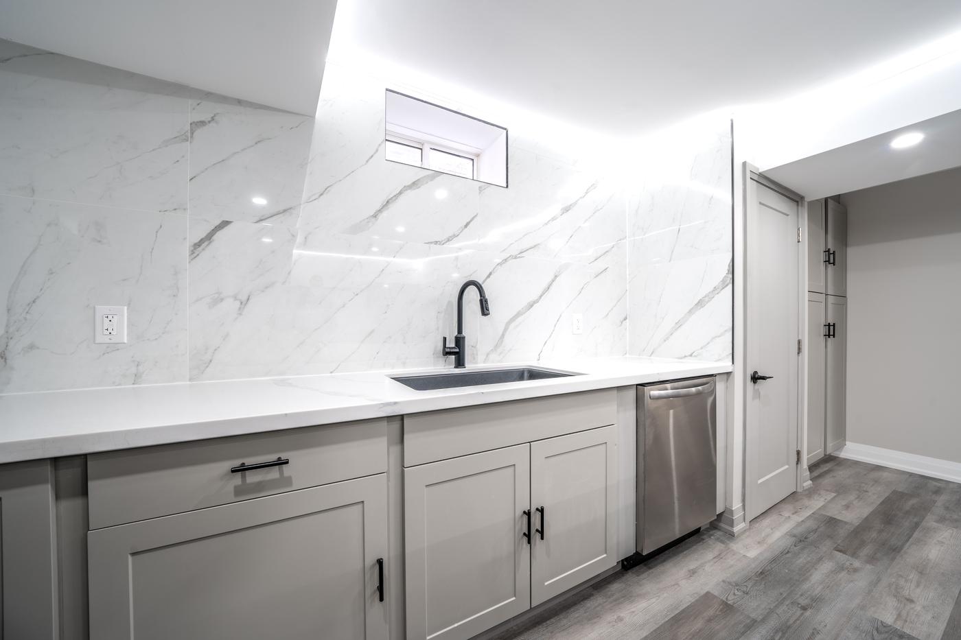 Open-Concept Basement Suite, Oshawa: Sink wall with a black pull-down faucet and dishwasher