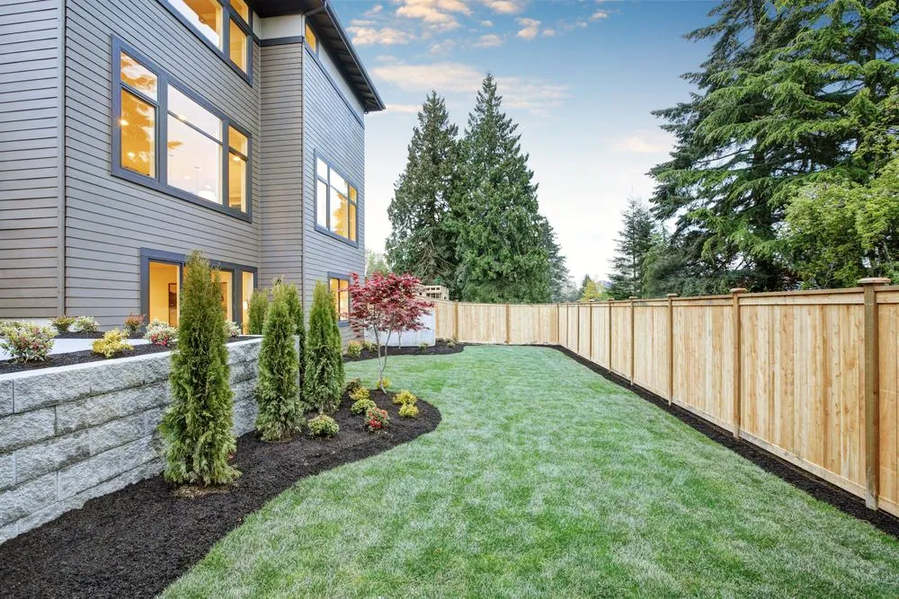 Cedar privacy fence along a landscaped backyard