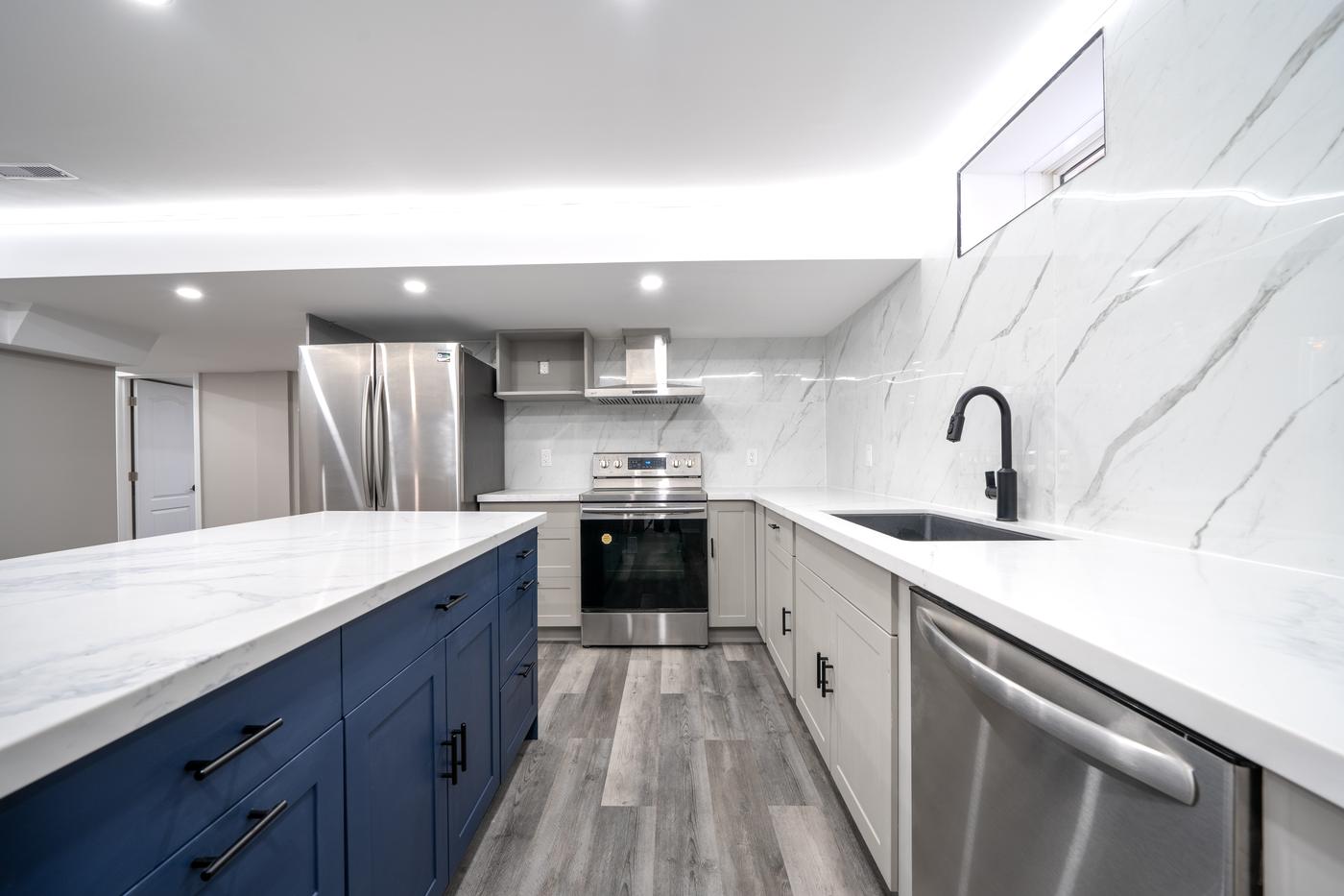 Open-Concept Basement Suite, Oshawa: Blue shaker island, range and undermount sink