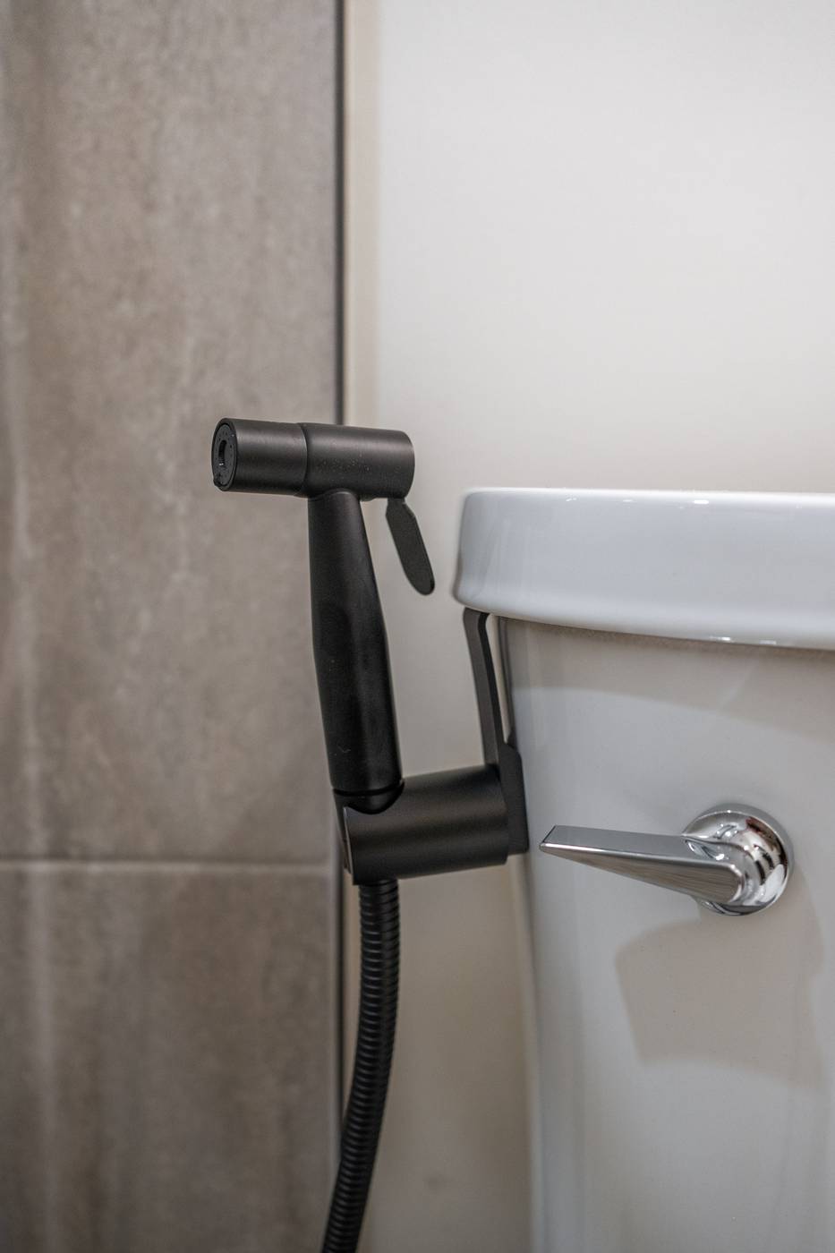 Taupe Herringbone Bathroom Retreat, Whitby: Matte black bidet sprayer beside the toilet