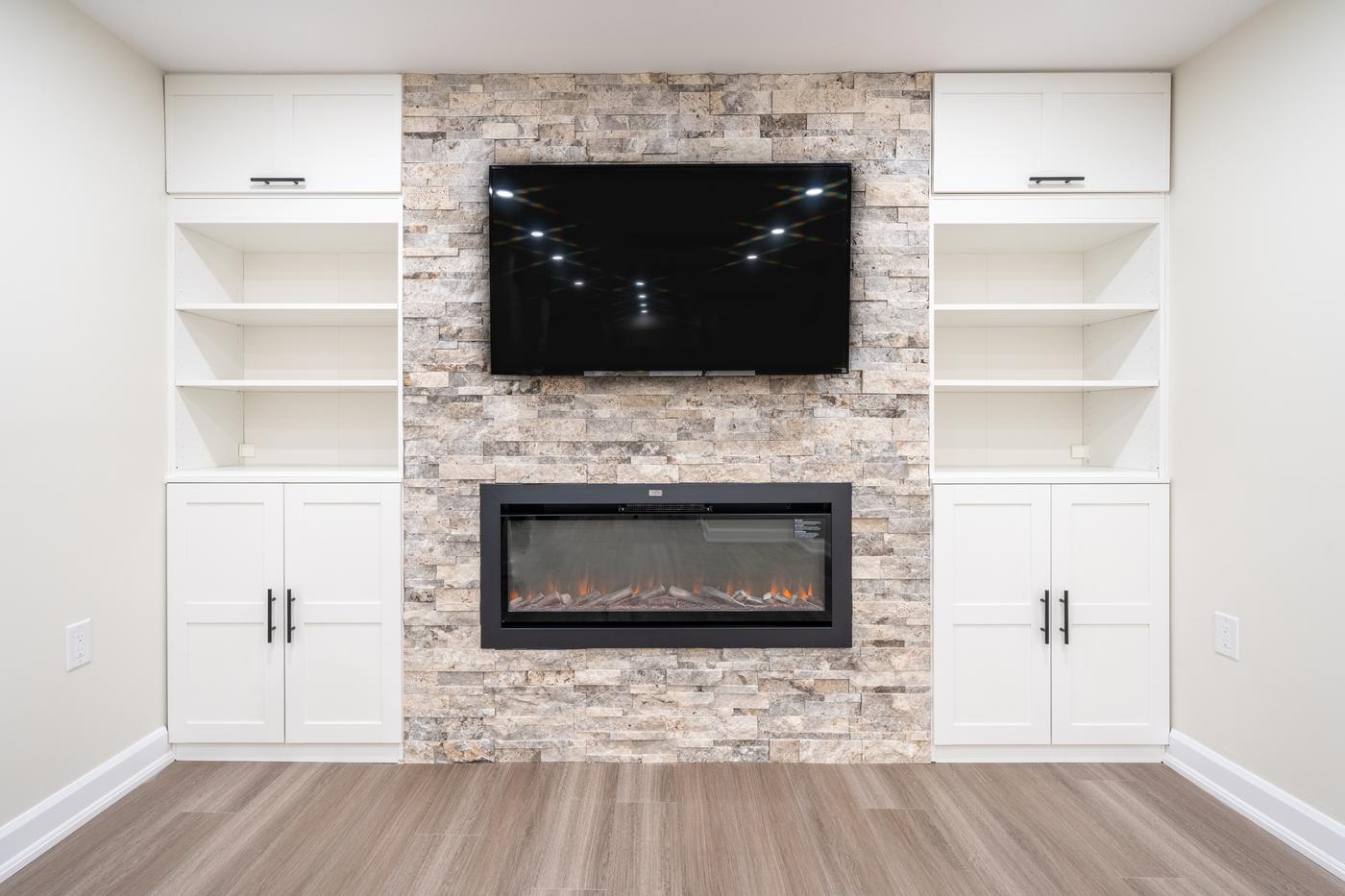 Stone Fireplace Basement Retreat, Oshawa: Stone fireplace with built-in shelving and cabinets