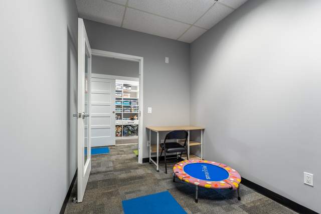 Dots for Kids Occupational Therapy Centre, Whitby: Small therapy room with a colourful mini trampoline and desk