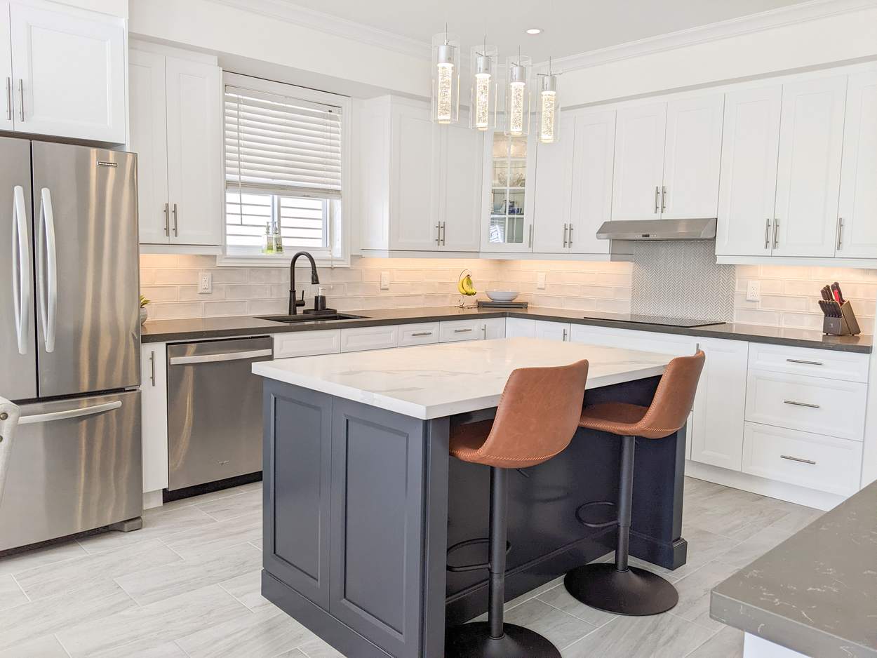 Chef's Kitchen and Entertainer's Basement, Whitby: Kitchen island with a quartz top, sink and stainless refrigerator