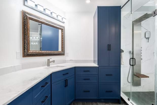 Marble and Navy Primary Ensuite, Courtice: Blue vanity with a tall storage cabinet