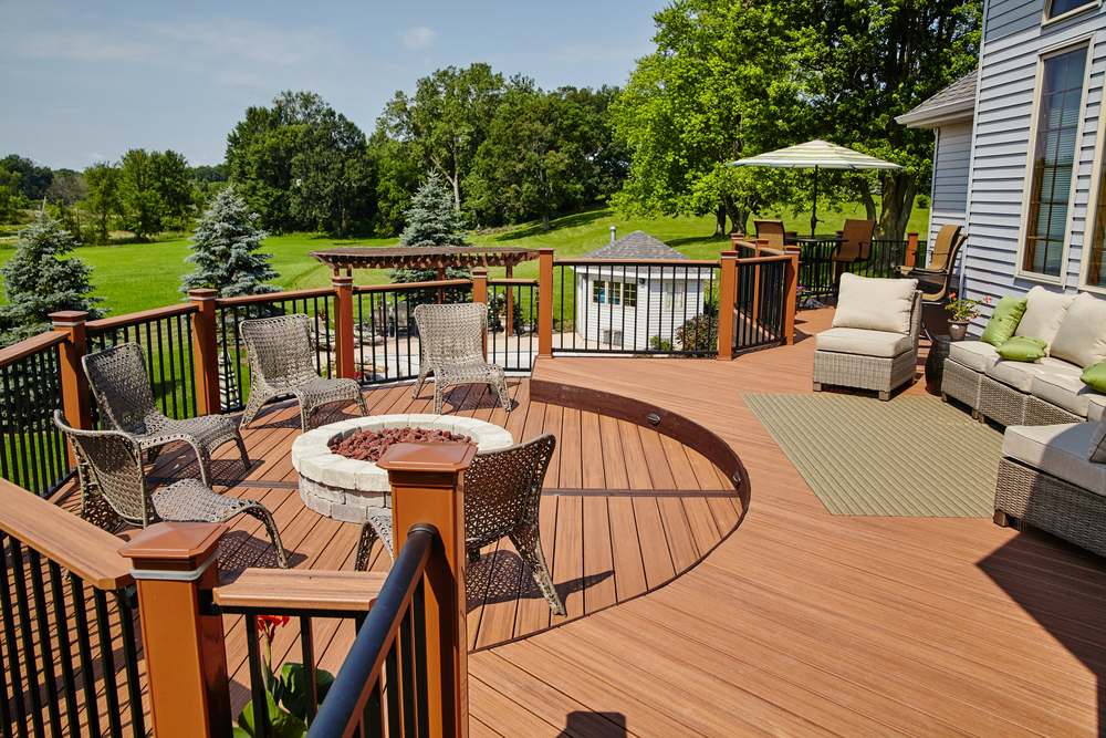 Multi-level composite deck with railings, a fire pit and outdoor seating
