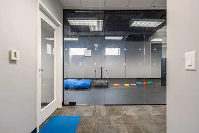 Dots for Kids Therapy Centre: Glass-walled sensory gym with a crash mat and stepping stones