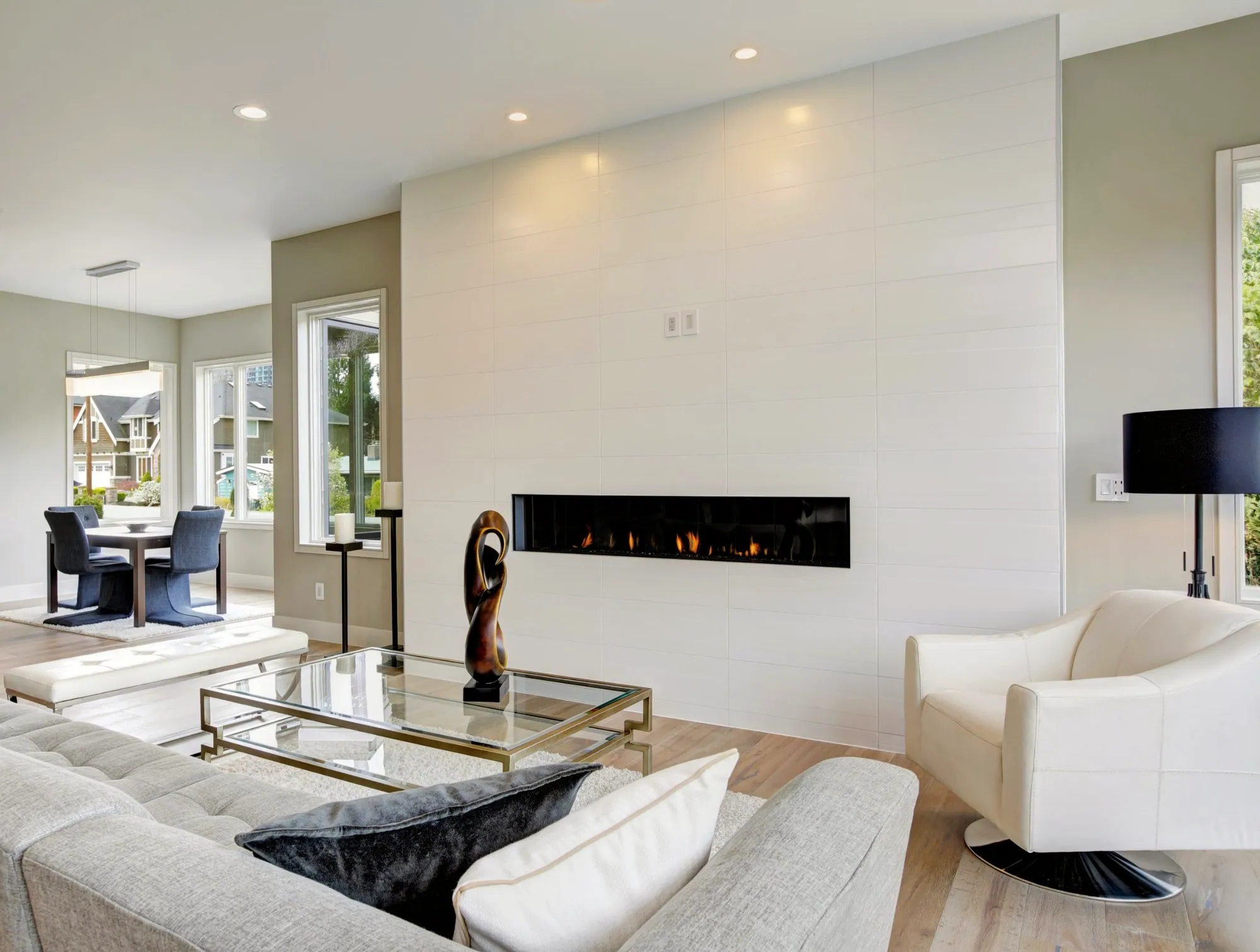 Living room with a white tile fireplace wall and a long linear gas fireplace