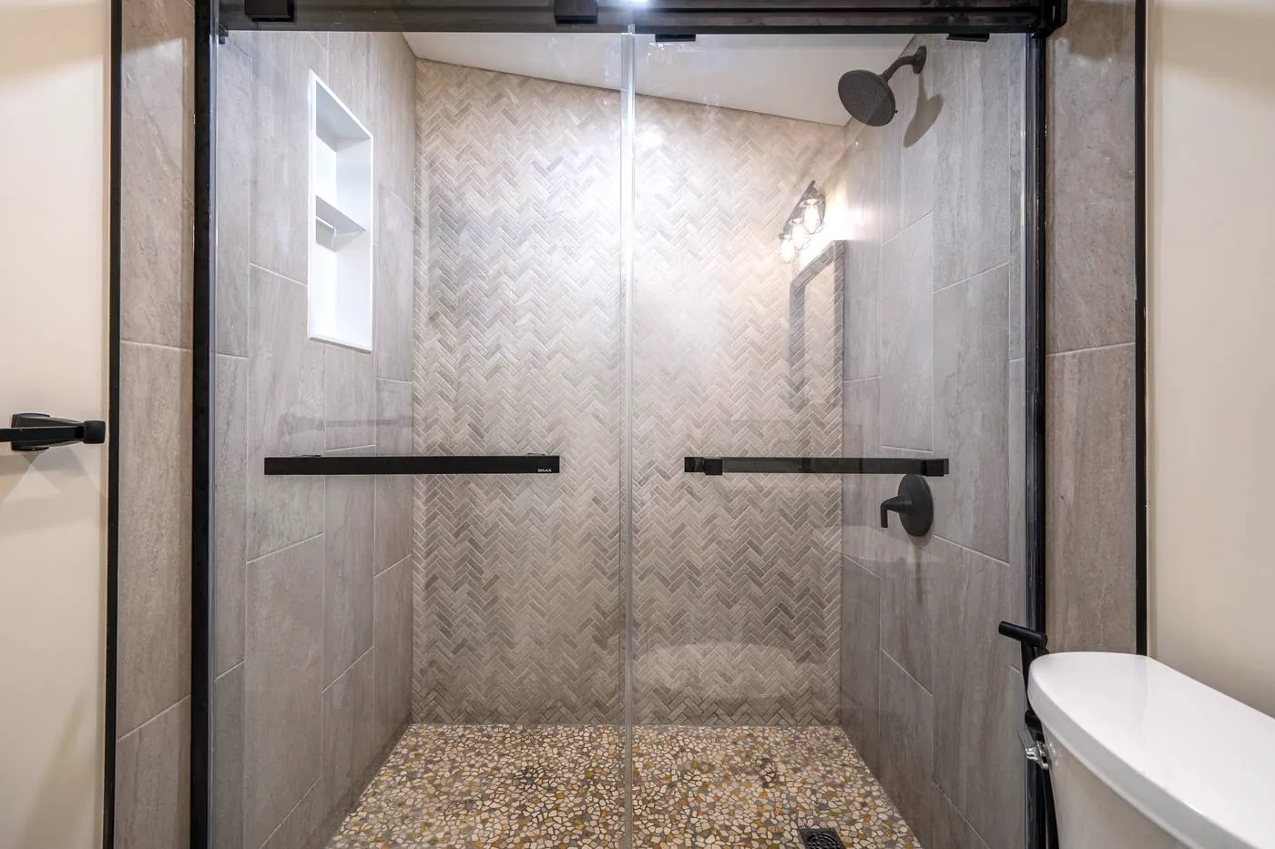 Herringbone shower wall with a pebble floor, Whitby